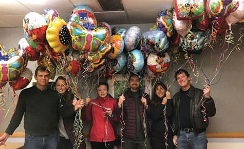 Family brings balloons to the hospital. 